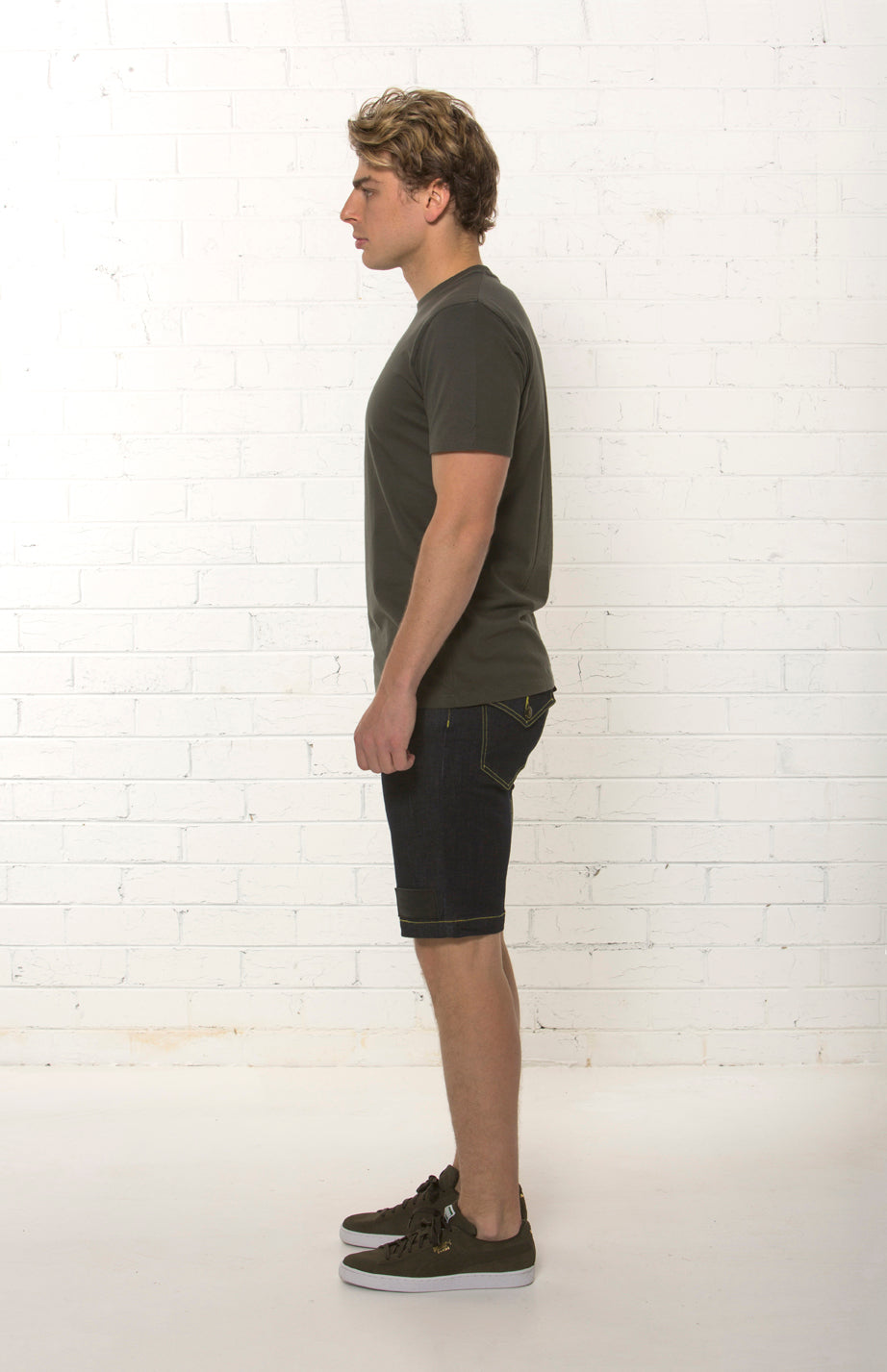 Side view of men's mid rise organic dark blue denim short by TRi COLOUR FEDERATiON