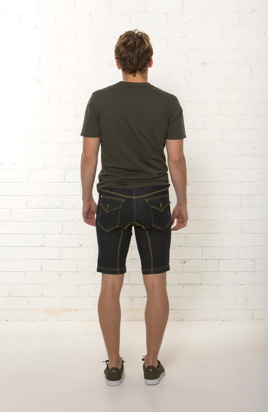 Back view of men's mid rise organic dark blue denim short by TRi COLOUR FEDERATiON